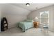 Well-lit bedroom with sloped ceilings, a bed, and natural light from a window at 2084 Democracy Dr, Buford, GA 30519
