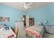 Cozy bedroom featuring a bed with a colorful quilt, a desk, and a white dresser at 2084 Democracy Dr, Buford, GA 30519