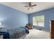 Simple bedroom featuring a bed, a window for natural light, and carpeted flooring at 2084 Democracy Dr, Buford, GA 30519