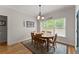 Inviting dining room featuring wood table, chandelier lighting, and natural light from large windows at 2084 Democracy Dr, Buford, GA 30519
