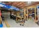 Unfinished garage space with exposed wooden beams, storage, and workspace at 2084 Democracy Dr, Buford, GA 30519