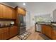 Modern kitchen with stainless steel appliances, dark countertops, and adjacent dining area at 2084 Democracy Dr, Buford, GA 30519