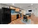 Kitchen area with stainless steel appliances, dark tile backsplash, and eat-in dining table at 2084 Democracy Dr, Buford, GA 30519