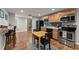 Modern kitchen area with stainless steel appliances, black subway tiles and an eat-in dining table at 2084 Democracy Dr, Buford, GA 30519