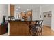 Kitchen with bar seating, stainless steel appliances, and access to wood floors at 2084 Democracy Dr, Buford, GA 30519