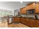 Modern kitchen with dark countertops, wood cabinets and stainless steel appliances at 2084 Democracy Dr, Buford, GA 30519