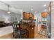 Open kitchen area with breakfast bar, stainless steel appliances and wood cabinets at 2084 Democracy Dr, Buford, GA 30519