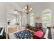 Elegant living room with natural light, hardwood floors, a chandelier, and ample space for relaxation or gatherings at 2084 Democracy Dr, Buford, GA 30519