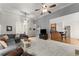 Open concept living room with modern decor flowing into the kitchen area at 2084 Democracy Dr, Buford, GA 30519