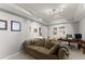 Comfortable living room with neutral colors, a sofa, desk, and wall decor at 2084 Democracy Dr, Buford, GA 30519