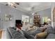 Comfortable living room with gray sofa, stone fireplace, and open view to the dining area at 2084 Democracy Dr, Buford, GA 30519