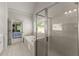 Luxurious bathroom boasts a glass-enclosed shower, soaking tub and a view of the main bedroom for seamless access at 2084 Democracy Dr, Buford, GA 30519
