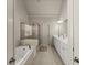 Bright bathroom showcasing a soaking tub, glass-enclosed shower and a double sink vanity with lots of storage at 2084 Democracy Dr, Buford, GA 30519