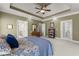 Comfortable main bedroom boasts a ceiling fan, carpeted floors, and access to an ensuite bathroom for convenience at 2084 Democracy Dr, Buford, GA 30519