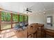 Screened porch features ceiling fan, string lights, and outdoor seating area at 2084 Democracy Dr, Buford, GA 30519