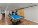 Finished basement recreational room featuring a pool table and wooden sliding barn doors at 2084 Democracy Dr, Buford, GA 30519