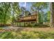 The rear of this home has a large wooden deck and a spacious backyard, offering a perfect setting for outdoor gatherings at 3957 Woodland Cir, Conyers, GA 30013