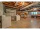 Unfinished basement featuring exposed duct work, shelving, laundry appliances, and a concrete floor at 3957 Woodland Cir, Conyers, GA 30013