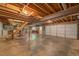 Spacious unfinished basement offering an entry to a garage and a set of stairs to the first floor at 3957 Woodland Cir, Conyers, GA 30013