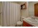 Cozy bathroom featuring a shower tub with a white curtain and a single sink vanity at 3957 Woodland Cir, Conyers, GA 30013