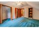 This bedroom has wood trim, blue carpet, a ceiling fan, closet, and an attached ensuite bathroom at 3957 Woodland Cir, Conyers, GA 30013