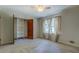 Bedroom with closet, ceiling fan, curtains, and large window at 3957 Woodland Cir, Conyers, GA 30013
