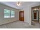 Bedroom featuring a ceiling fan, closet and a large window overlooking backyard at 3957 Woodland Cir, Conyers, GA 30013