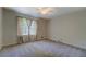 Bedroom with carpet floors, curtains, ceiling fan, and large window at 3957 Woodland Cir, Conyers, GA 30013