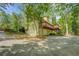 Rear exterior view featuring a spacious two-story deck, a two-car garage, and ample parking space on the paved driveway at 3957 Woodland Cir, Conyers, GA 30013