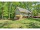 Side view of cozy home surrounded by greenery and beautiful landscaping, providing a private and serene setting at 3957 Woodland Cir, Conyers, GA 30013