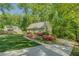 A well-maintained lawn and colorful flower beds add to the curb appeal of this one-story home surrounded by mature trees at 3957 Woodland Cir, Conyers, GA 30013