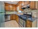 Kitchen with stainless steel appliances, gas range, and wood cabinets at 3957 Woodland Cir, Conyers, GA 30013