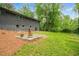 Spacious backyard with manicured lawn, mature trees, and patio area at 4206 Lake Laurel Se Dr, Smyrna, GA 30082
