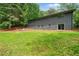 Exterior view of the backyard showcasing its green lawn, patio, and mature trees at 4206 Lake Laurel Se Dr, Smyrna, GA 30082