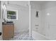 Bright bathroom featuring stylish patterned floors, a modern vanity, and a tiled shower and tub at 4206 Lake Laurel Se Dr, Smyrna, GA 30082