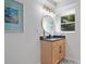 Bright bathroom with natural wood vanity, decorative mirror, and stylish patterned floor at 4206 Lake Laurel Se Dr, Smyrna, GA 30082