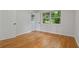 Empty bedroom with hardwood floors and a view to the outside through a large window at 4206 Lake Laurel Se Dr, Smyrna, GA 30082
