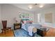 Stylish bedroom with a comfortable bed, wood floors, and natural light at 4206 Lake Laurel Se Dr, Smyrna, GA 30082