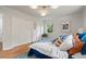 Cozy bedroom with hardwood floors, a large window, and modern light fixture at 4206 Lake Laurel Se Dr, Smyrna, GA 30082