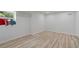 Minimalist bedroom with wood floors, white walls, and a window showcasing outdoor views at 4206 Lake Laurel Se Dr, Smyrna, GA 30082