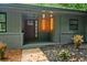 Close-up of a covered front porch with wood door, address number, and modern lighting at 4206 Lake Laurel Se Dr, Smyrna, GA 30082
