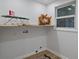 Bright laundry room featuring wooden shelf, convenient outlet, and patterned floor tile at 4206 Lake Laurel Se Dr, Smyrna, GA 30082