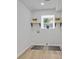 Well-lit laundry room featuring tile floors, two shelves, and a window at 4206 Lake Laurel Se Dr, Smyrna, GA 30082