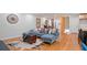 Open-concept living area with a sectional sofa, hardwood floors, and a view into other spaces at 4206 Lake Laurel Se Dr, Smyrna, GA 30082