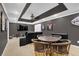 Finished basement boasting movie seating, sports artwork and a table with unique chairs at 4410 Red Rock Pt, Suwanee, GA 30024