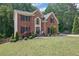 Charming two-story brick home with well-manicured lawn and mature landscaping at 4410 Red Rock Pt, Suwanee, GA 30024