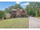Beautiful two-story brick home with a lush green lawn and a long driveway at 4410 Red Rock Pt, Suwanee, GA 30024
