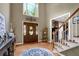 Grand Foyer featuring hardwood floors, high ceilings, and an elegant front door at 4410 Red Rock Pt, Suwanee, GA 30024