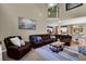 Spacious living room featuring a sectional sofa and open to the dining room at 4410 Red Rock Pt, Suwanee, GA 30024