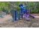 Community playground featuring climbing wall and slides with safety mulch, providing a fun outdoor space for children at 4410 Red Rock Pt, Suwanee, GA 30024